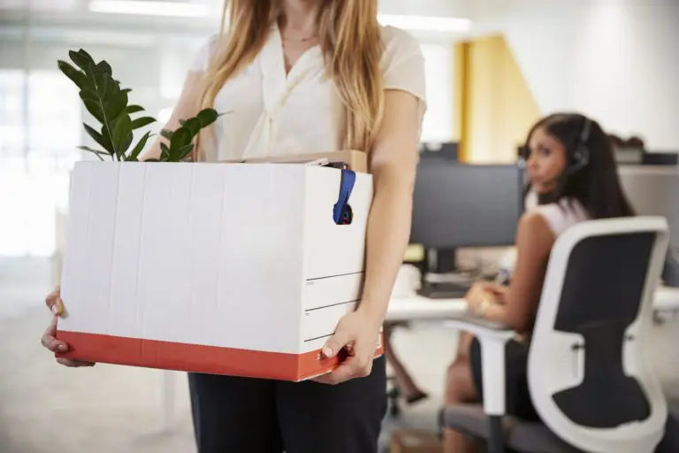 fired-female-employee-holding-box-of-belongings