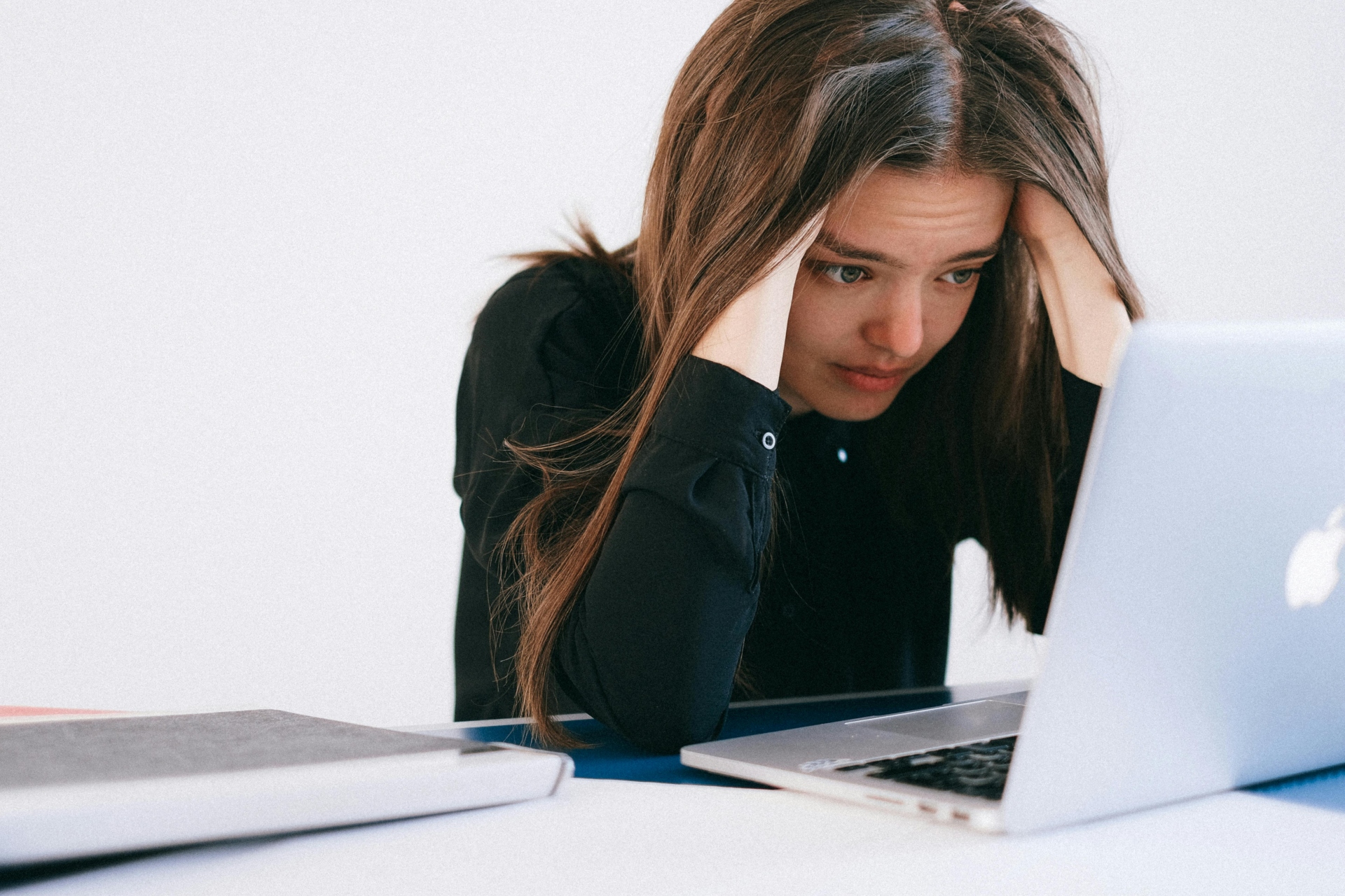 a young woman looking frustrated in front of her computer_ wrongful termination